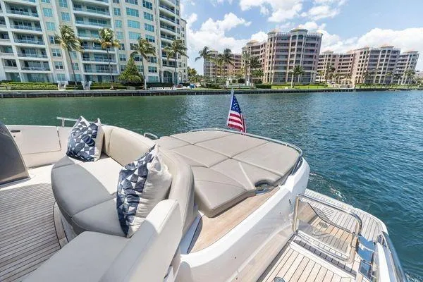 Endless Summer Yacht Photos Pics Luxurious 2020 Princess V55 yacht with elegant seating, docked near waterfront condos.