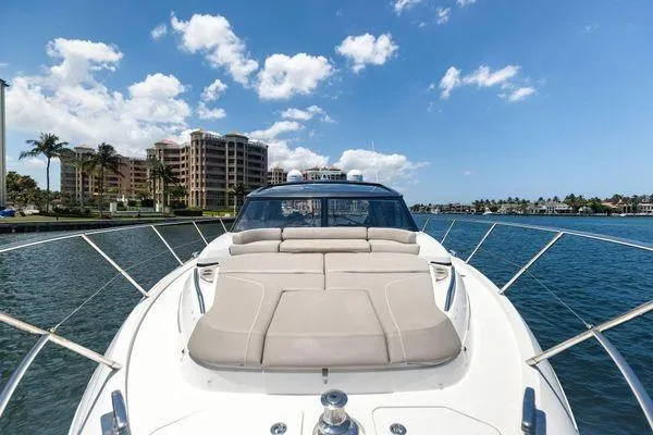 Endless Summer Yacht Photos Pics 2020 Princess V55 yacht cruising near waterfront buildings under a clear blue sky.