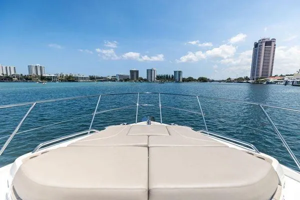 Endless Summer Yacht Photos Pics Bow view of 2020 Princess V55 yacht cruising near city skyline.