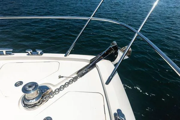 Endless Summer Yacht Photos Pics Bow of 2020 Princess V55 yacht with anchor and chain on blue water.