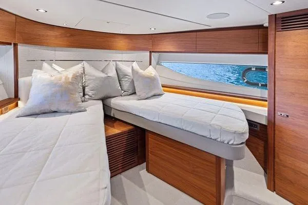 Endless Summer Yacht Photos Pics Luxurious cabin interior of 2020 Princess V55 yacht with twin beds and elegant wood finish.