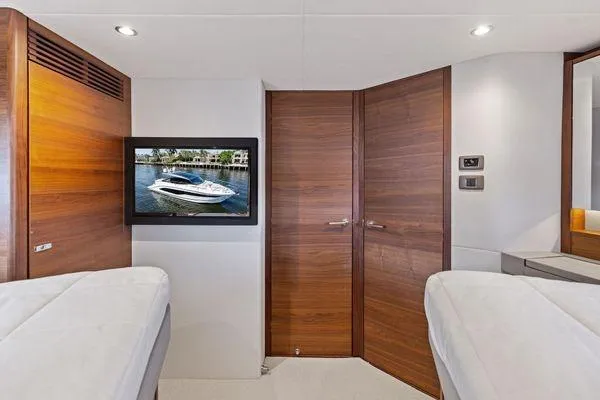 Endless Summer Yacht Photos Pics Luxurious interior of 2020 Princess V55 yacht with wood paneling and mounted TV.