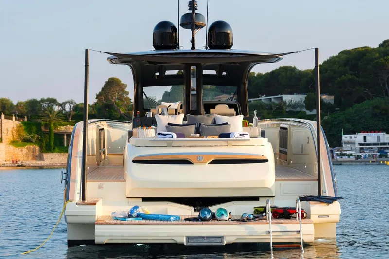  Yacht Photos Pics 2023 Invictus TT460 yacht with luxurious deck, docked in scenic waters.