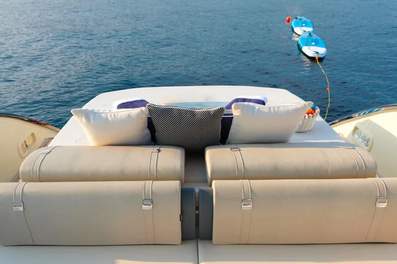  Yacht Photos Pics Luxurious 2023 Invictus TT460 yacht deck with cushions, overlooking serene ocean waters.