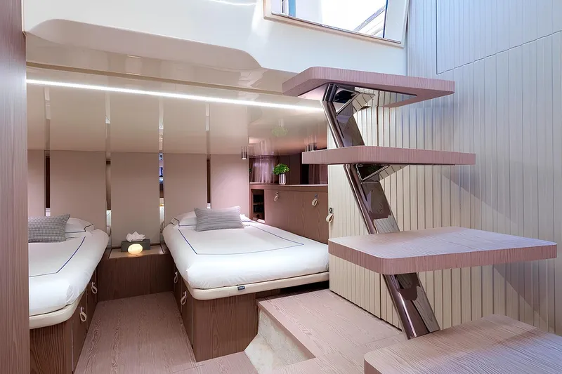  Yacht Photos Pics Luxurious interior of 2023 Invictus TT460 yacht with modern twin beds and sleek staircase.