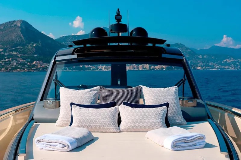  Yacht Photos Pics Luxurious 2023 Invictus TT460 yacht with plush cushions, towels, and scenic ocean view.