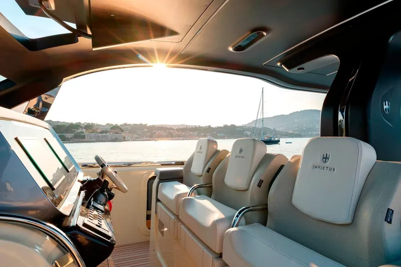  Yacht Photos Pics Luxurious interior of 2023 Invictus TT460 yacht with elegant seating and scenic ocean view.