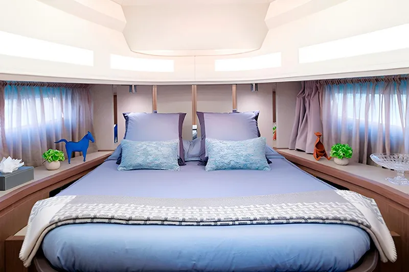  Yacht Photos Pics Luxurious bedroom interior of 2023 Invictus TT460 yacht with elegant decor and soft lighting.