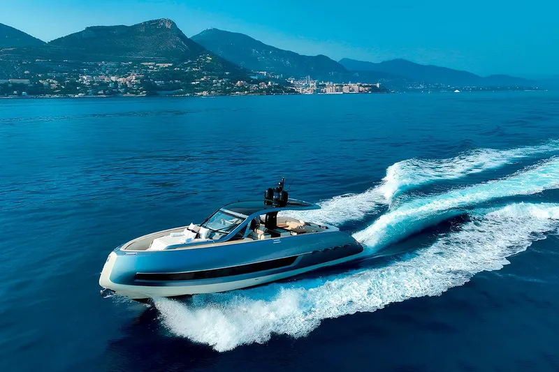  Yacht Photos Pics 2023 Invictus TT460 yacht cruising on blue ocean with scenic mountain backdrop.