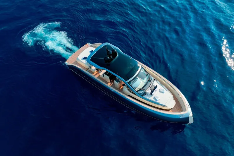 Yacht Photos Pics Aerial view of 2023 Invictus TT460 luxury yacht cruising on deep blue ocean waters.