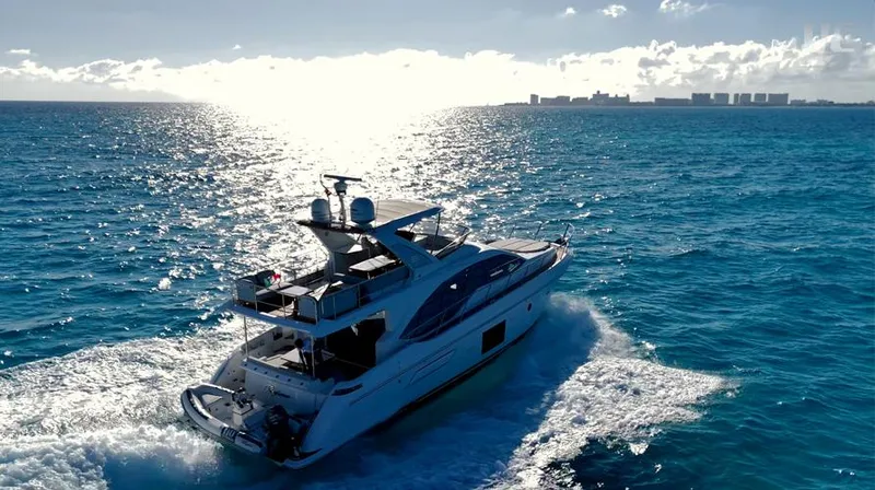 Resilience Yacht Photos Pics Luxurious 2021 Azimut 55 yacht cruising on open sea under clear skies.