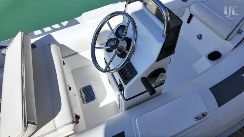 Resilience Yacht Photos Pics Interior view of 2021 Azimut 55 yacht, featuring sleek steering wheel and seating.