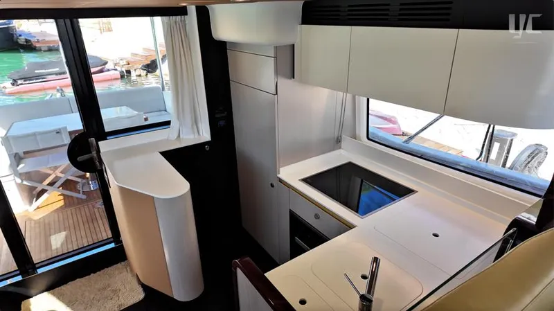 Resilience Yacht Photos Pics Modern kitchen interior of 2021 Azimut 55 yacht, featuring sleek design and large windows.