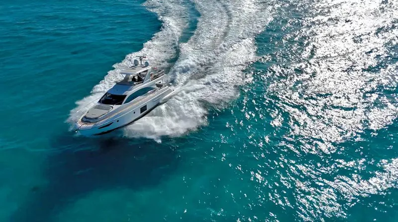Resilience Yacht Photos Pics Aerial view of 2021 Azimut 55 yacht cruising on clear blue ocean waters.