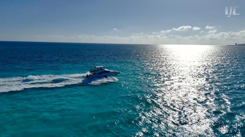 Resilience Yacht Photos Pics Azimut 55 yacht cruising on clear blue ocean under sunny sky, 2021 model.