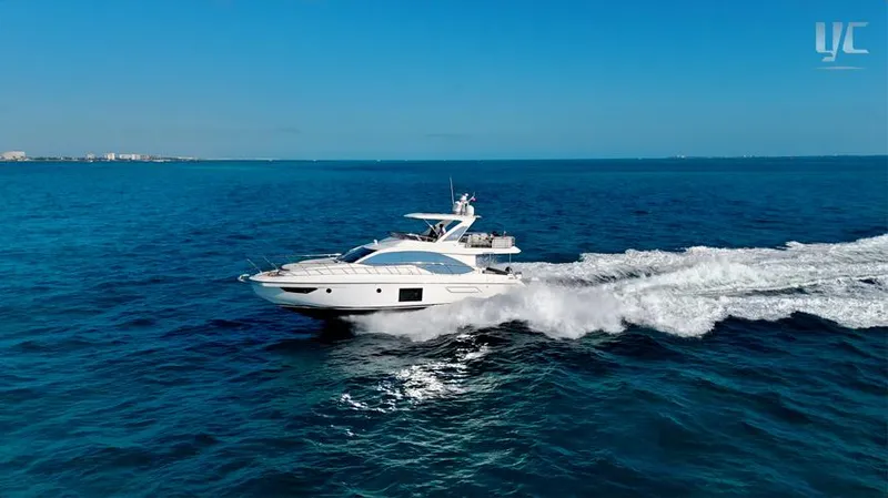 Resilience Yacht Photos Pics Azimut 55 yacht cruising on open sea, 2021 model, under clear blue sky.