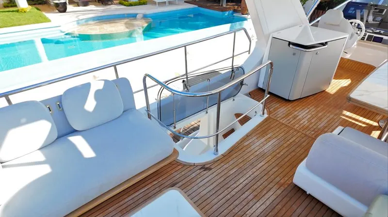 Resilience Yacht Photos Pics Luxurious 2021 Azimut 55 yacht deck with seating, near a pool.