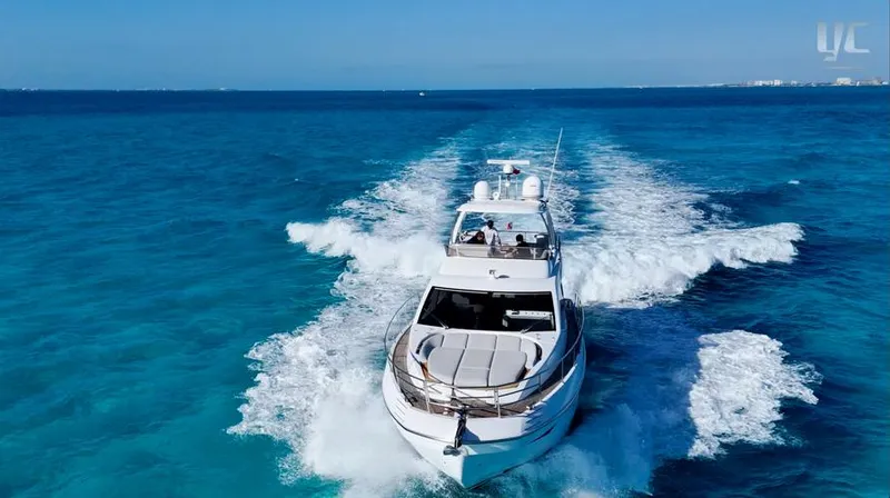 Resilience Yacht Photos Pics Luxurious 2021 Azimut 55 yacht cruising on clear blue ocean waters.