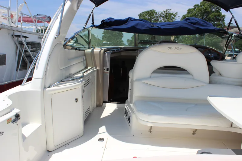  Yacht Photos Pics 2003 Sea Ray 380 Sundancer interior with white seating and blue canopy.
