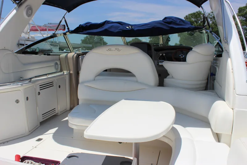  Yacht Photos Pics 2003 Sea Ray 380 Sundancer interior with white seating and table under blue canopy.