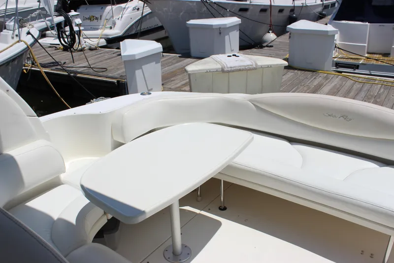  Yacht Photos Pics 2003 Sea Ray 380 Sundancer yacht interior with white seating and table at dock.
