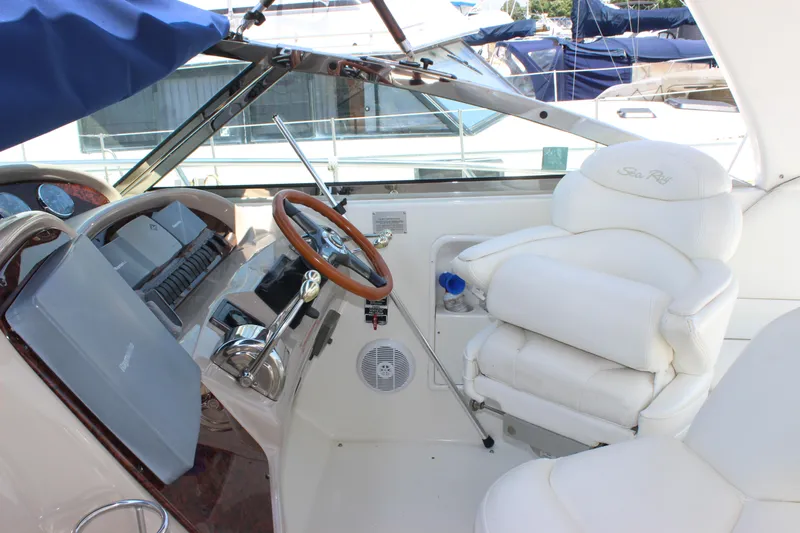  Yacht Photos Pics 2003 Sea Ray 380 Sundancer helm with white leather seating and wooden steering wheel.