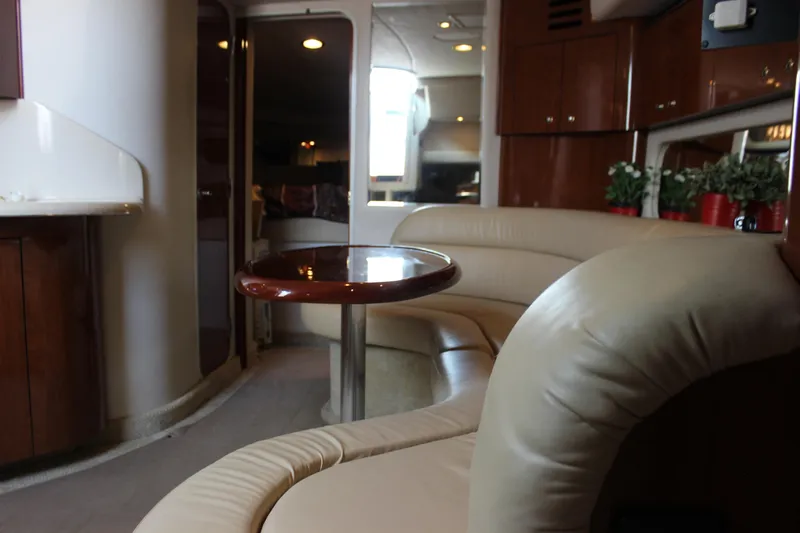  Yacht Photos Pics Interior of 2003 Sea Ray 380 Sundancer yacht with leather seating and wooden table.