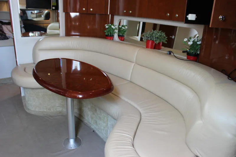  Yacht Photos Pics Luxurious interior of 2003 Sea Ray 380 Sundancer with leather seating and wooden table.