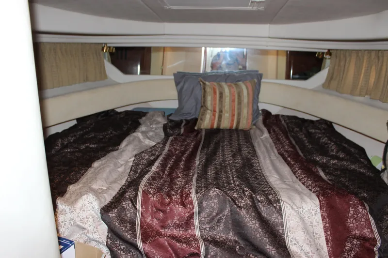  Yacht Photos Pics Cozy cabin interior of 2003 Sea Ray 380 Sundancer with patterned bedding and pillows.