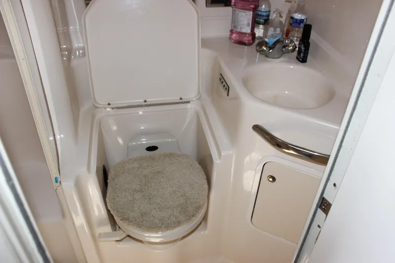  Yacht Photos Pics Bathroom interior of 2003 Sea Ray 380 Sundancer yacht, featuring a compact toilet and sink.
