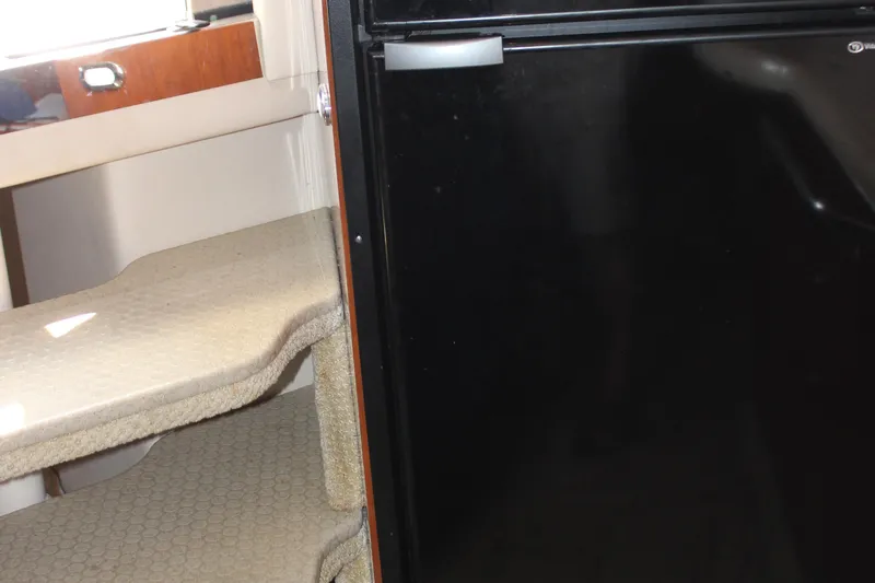  Yacht Photos Pics Interior view of 2003 Sea Ray 380 Sundancer with carpeted steps and black refrigerator.