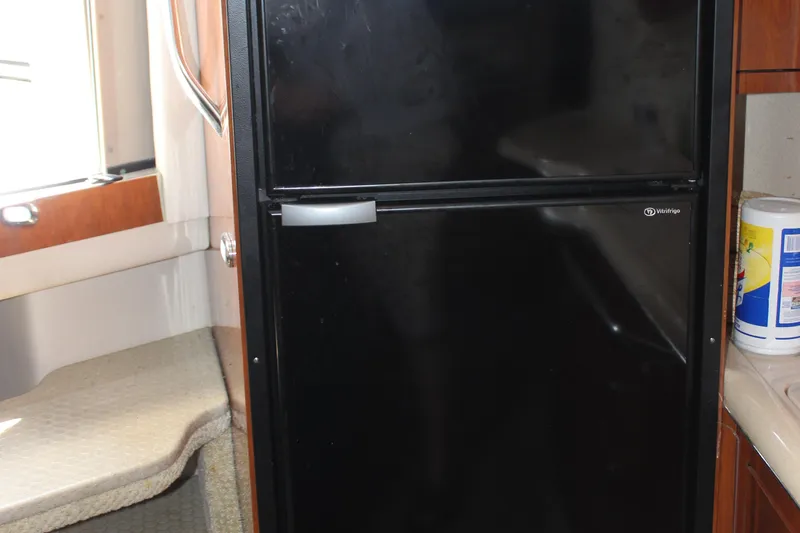  Yacht Photos Pics Black refrigerator inside 2003 Sea Ray 380 Sundancer yacht kitchen area.