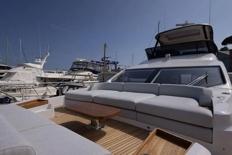  Yacht Photos Pics Luxurious 2022 Azimut Fly 68 yacht with spacious deck and elegant seating at marina.