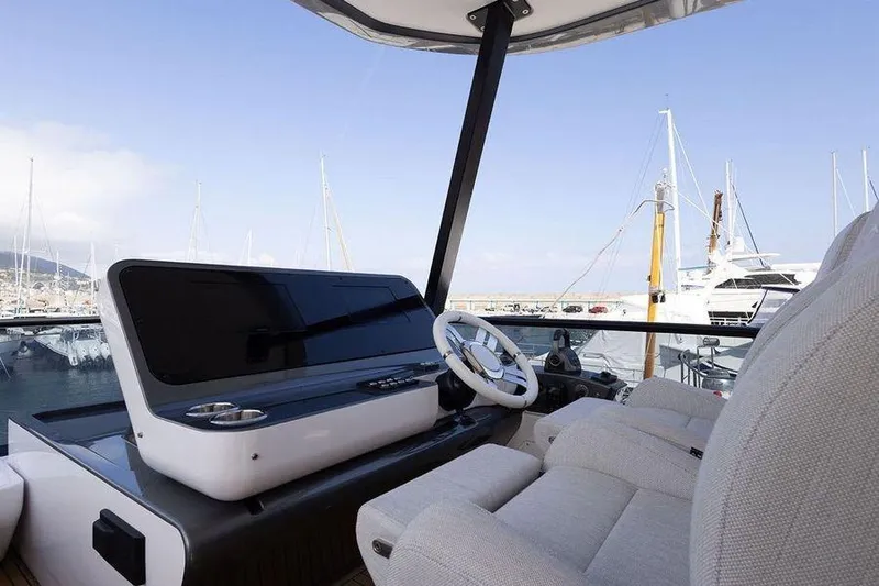  Yacht Photos Pics Luxurious 2022 Azimut Fly 68 yacht helm with marina view.