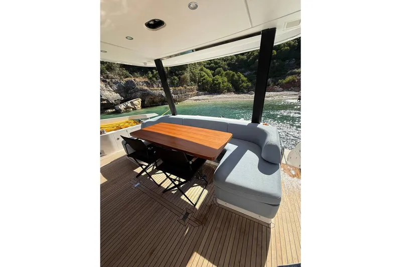  Yacht Photos Pics Luxurious 2022 Azimut Fly 68 yacht deck with elegant seating and scenic coastal view.
