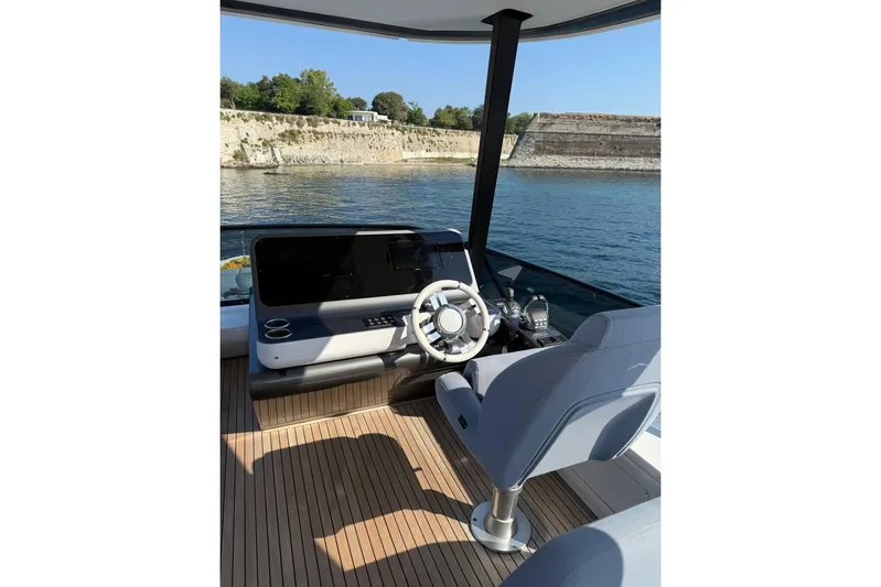  Yacht Photos Pics Helm of 2022 Azimut Fly 68 yacht with modern controls and scenic water view.