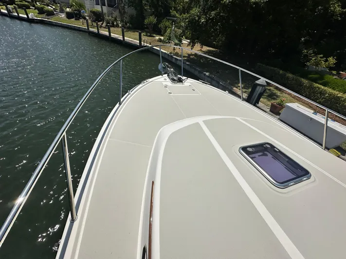  Yacht Photos Pics 2022 Back Cove 372 boat deck with railing, docked by a canal.