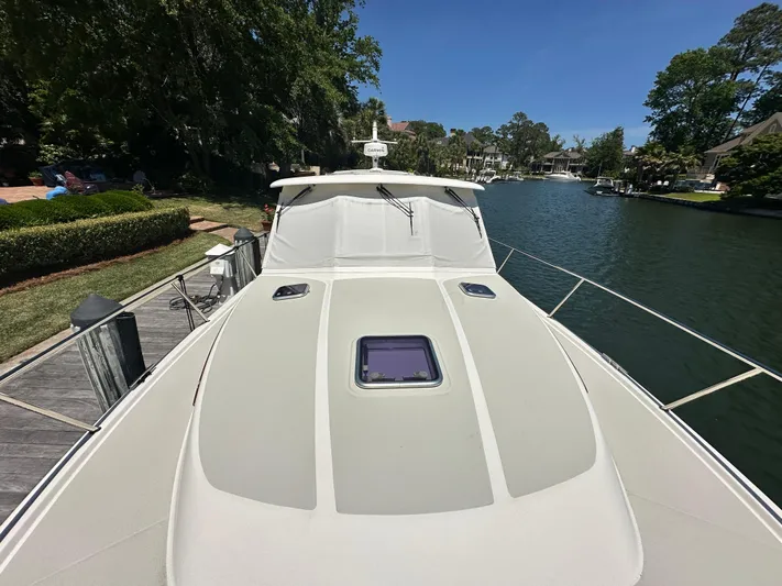  Yacht Photos Pics 2022 Back Cove 372 yacht docked by a scenic waterfront.
