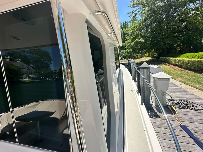  Yacht Photos Pics 2022 Back Cove 372 yacht docked, showcasing sleek design and reflective windows.