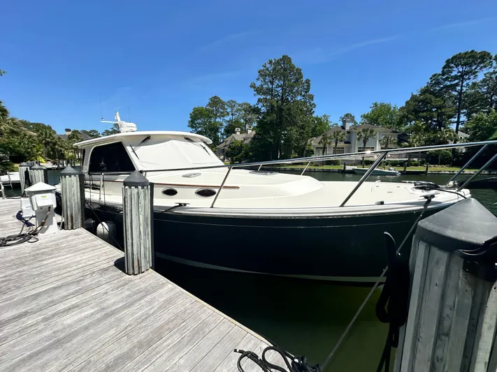  Yacht Photos Pics 2022 Back Cove 372 boat docked at a marina under clear blue skies.