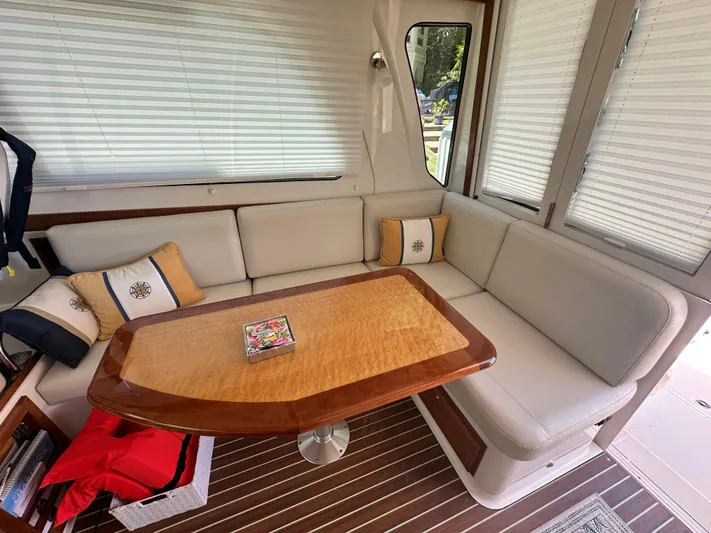 Yacht Photos Pics Luxurious interior of 2022 Back Cove 372 yacht with elegant seating and wooden table.