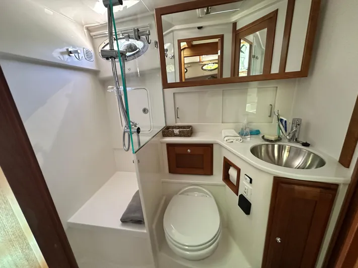  Yacht Photos Pics Luxurious bathroom in 2022 Back Cove 372 yacht with modern fixtures and elegant wood accents.