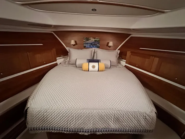  Yacht Photos Pics Luxurious cabin interior of 2022 Back Cove 372 yacht with elegant bedding and wood paneling.