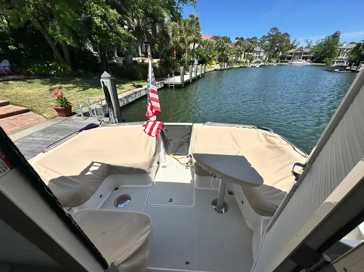  Yacht Photos Pics 2022 Back Cove 372 boat docked by a scenic waterfront with lush greenery.