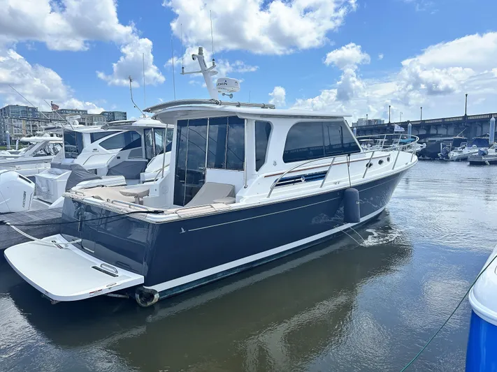  Yacht Photos Pics 2022 Back Cove 372 yacht docked in marina under blue sky.