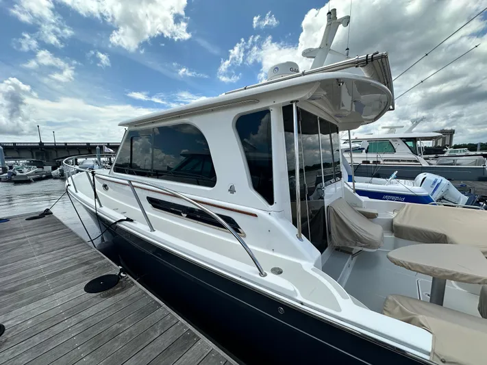  Yacht Photos Pics 2022 Back Cove 372 yacht docked at marina under cloudy sky.