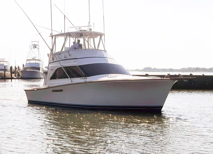 Occtane Yacht Photos Pics 1990 Ocean Yachts 44 Super Sport boat docked in a marina, sunny day.