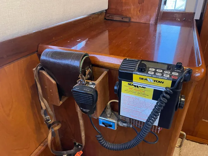 Occtane Yacht Photos Pics VHF radio equipment on 1990 Ocean Yachts 44 Super Sport, featuring wood paneling and communication tools.