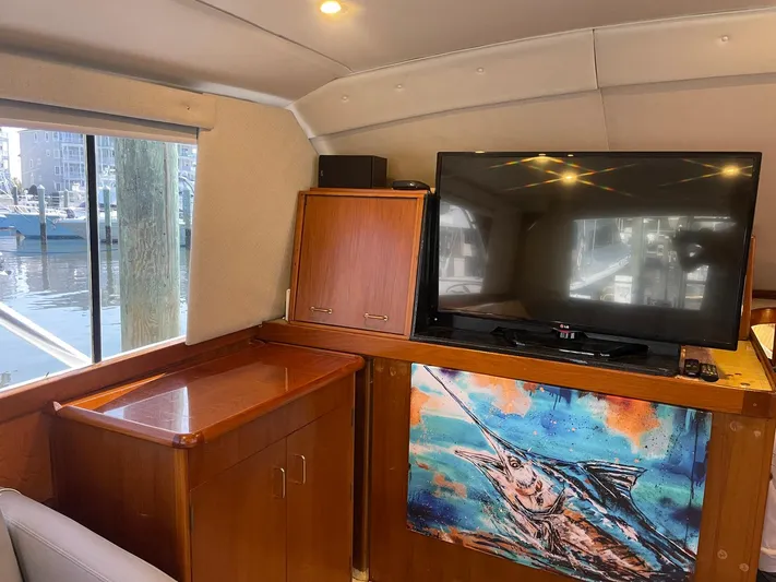 Occtane Yacht Photos Pics Interior of 1990 Ocean Yachts 44 Super Sport with TV and marlin artwork.
