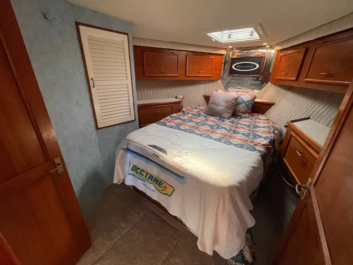 Occtane Yacht Photos Pics Cozy bedroom in 1990 Ocean Yachts 44 Super Sport with wood cabinetry and skylight.